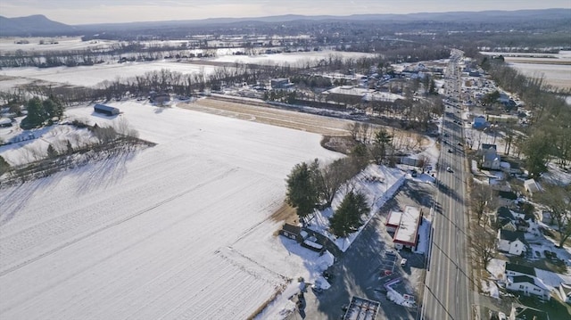 snowy aerial view with a mountain view