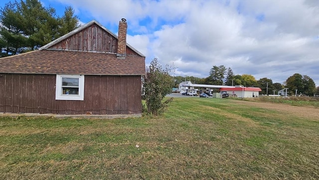 view of side of property with a yard