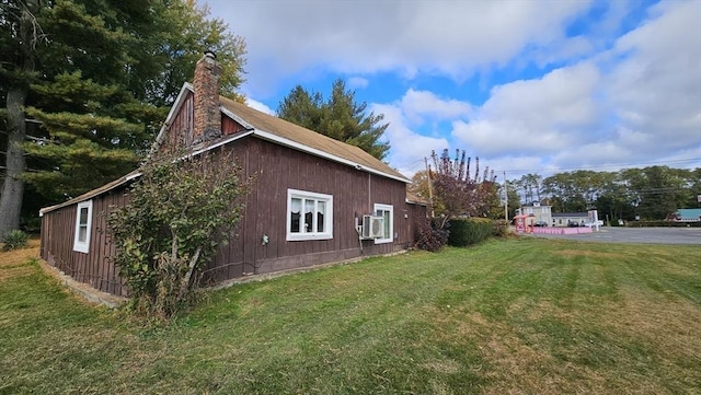 view of property exterior with a yard and cooling unit