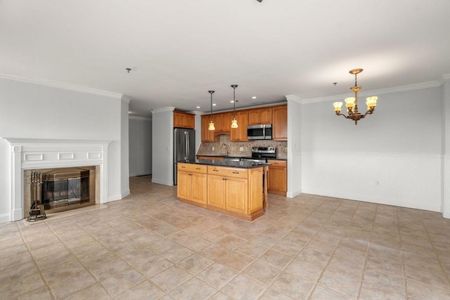 kitchen with appliances with stainless steel finishes, a chandelier, dark countertops, crown molding, and decorative backsplash