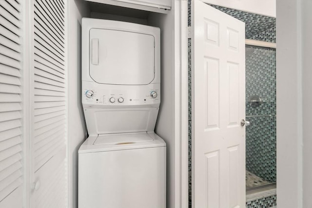 washroom featuring stacked washing machine and dryer