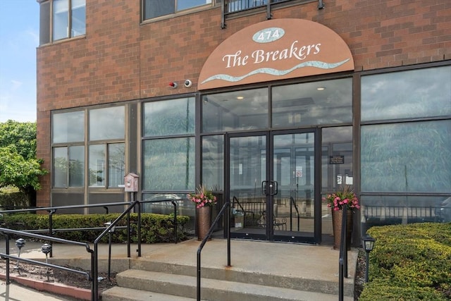 view of exterior entry with brick siding