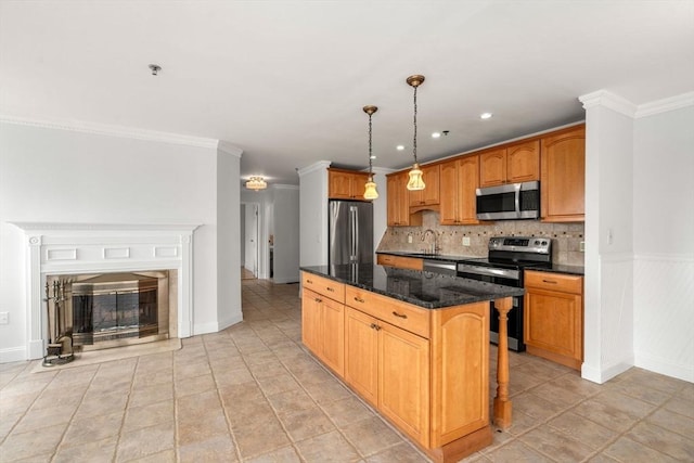 kitchen with stainless steel appliances, a center island, a sink, dark stone counters, and tasteful backsplash