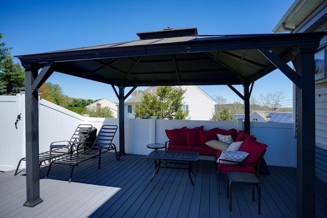 deck featuring an outdoor hangout area, fence, and a gazebo