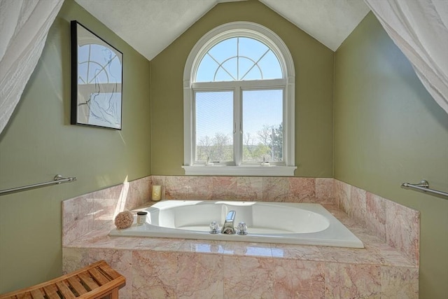 full bath featuring a bath and vaulted ceiling