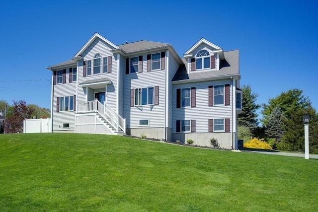 view of front of property featuring fence and a front yard