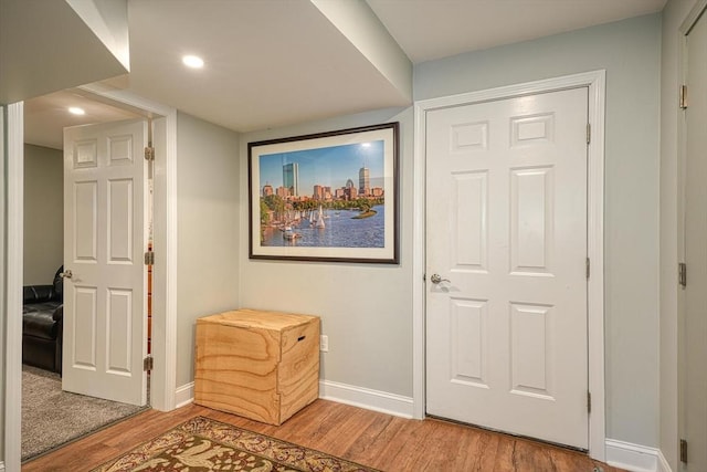 entryway with baseboards, recessed lighting, and light wood-style flooring
