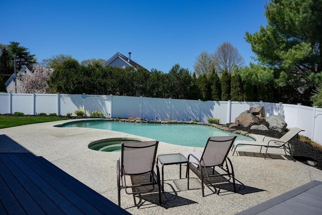view of pool with a deck, an in ground hot tub, a fenced in pool, and a fenced backyard