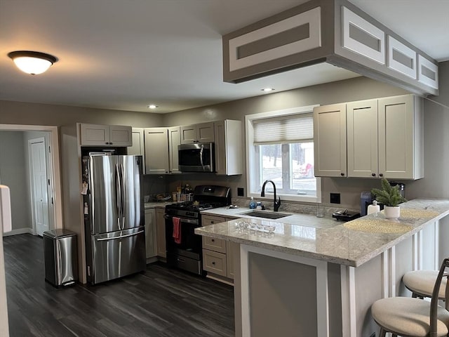445 Cambridge St, Worcester, MA 01610 - kitchen with stainless steel appliances, a sink, a peninsula, dark wood-style flooring, and recessed lighting