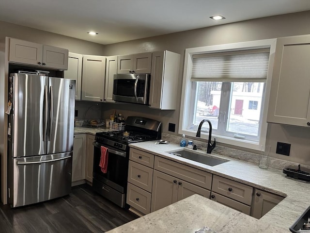 445 Cambridge St, Worcester, MA 01610 - kitchen with stainless steel appliances, a sink, light stone counters, dark wood-type flooring, and recessed lighting