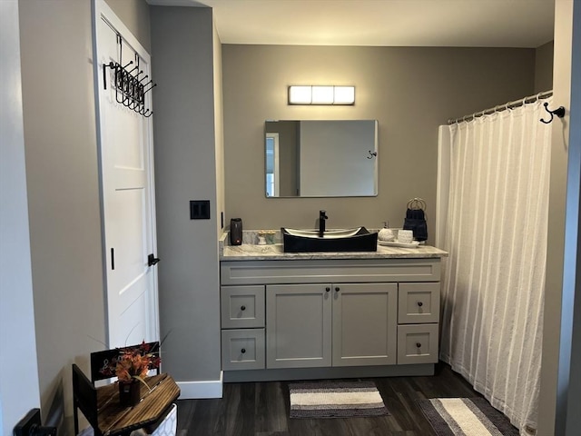 445 Cambridge St, Worcester, MA 01610 - bathroom featuring wood finished floors, vanity, baseboards, and a shower with shower curtain