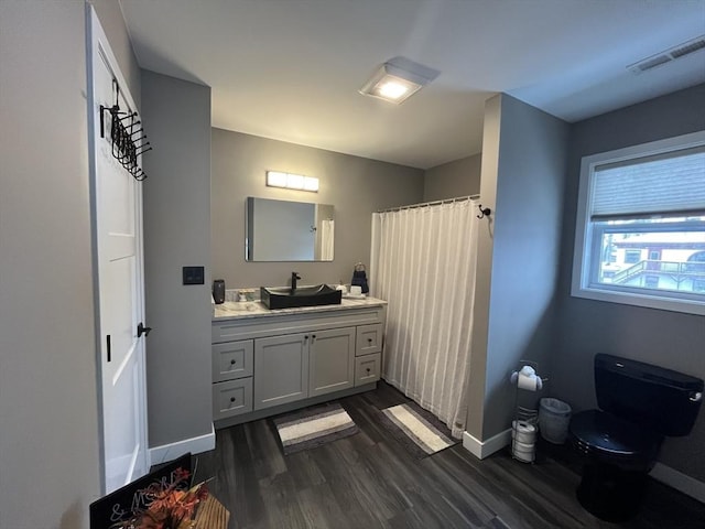 445 Cambridge St, Worcester, MA 01610 - full bath featuring vanity, toilet, wood finished floors, baseboards, and a shower with curtain