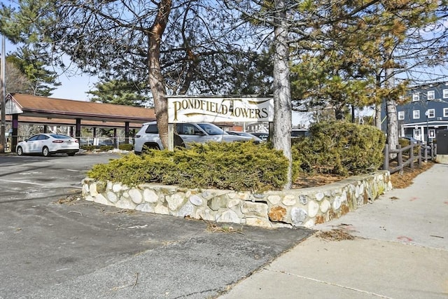 community / neighborhood sign with covered and uncovered parking