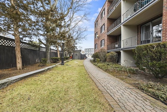 surrounding community with fence and a lawn