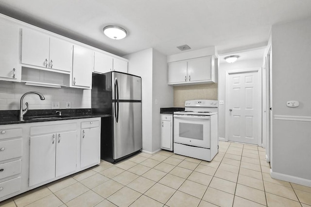 kitchen featuring a sink, white cabinets, freestanding refrigerator, tasteful backsplash, and white electric range oven