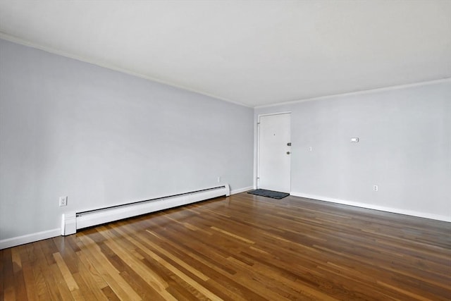 unfurnished room featuring baseboards, baseboard heating, wood-type flooring, and crown molding