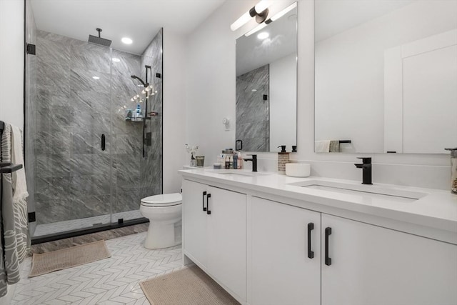 bathroom featuring tile patterned flooring, vanity, toilet, and an enclosed shower