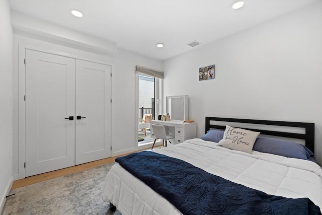 bedroom featuring light wood-type flooring and a closet