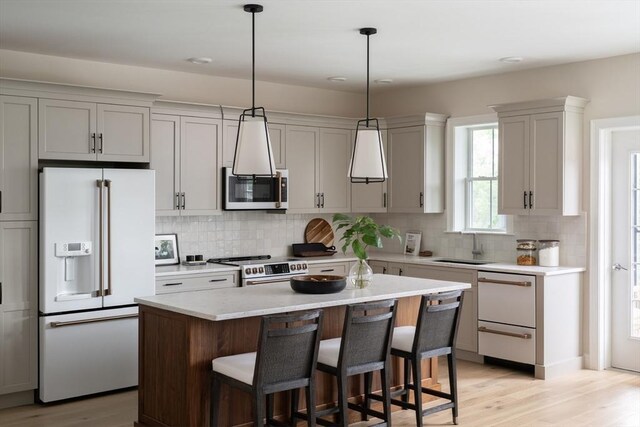 kitchen featuring decorative backsplash, white appliances, decorative light fixtures, and sink