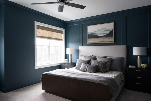 carpeted bedroom featuring ceiling fan and crown molding