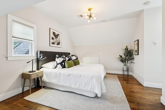 bedroom featuring a chandelier, baseboards, wood finished floors, and lofted ceiling
