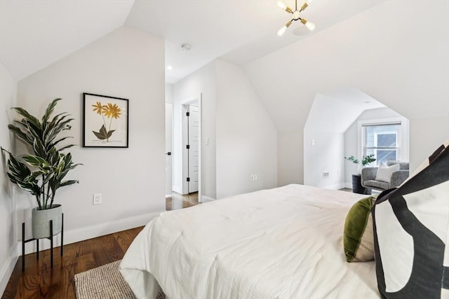 bedroom with lofted ceiling, wood finished floors, and baseboards
