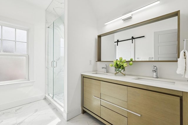 full bath featuring marble look tiles, a marble finish shower, baseboards, and double vanity