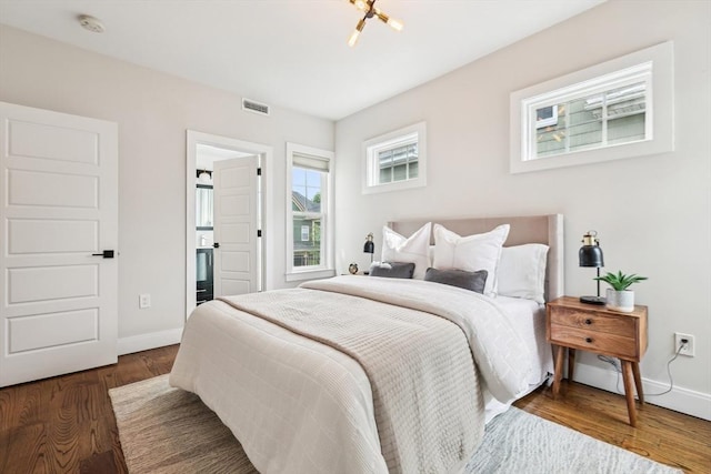 bedroom featuring baseboards and wood finished floors