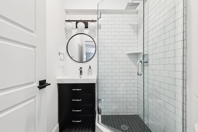 bathroom with a shower stall and vanity