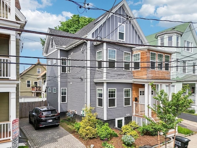 view of property exterior with roof with shingles