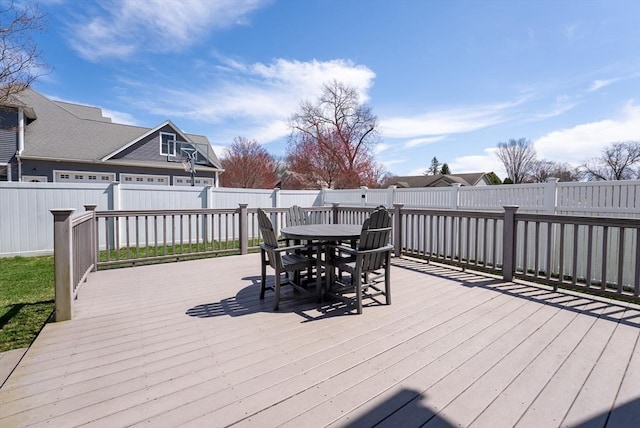 wooden terrace featuring a fenced backyard and outdoor dining space
