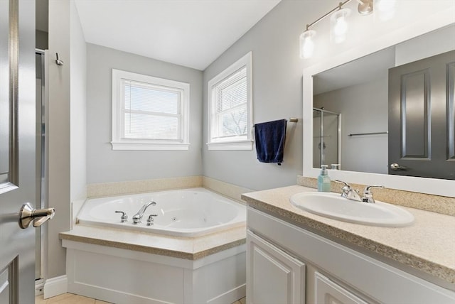 full bathroom with a tub with jets, vanity, and a stall shower