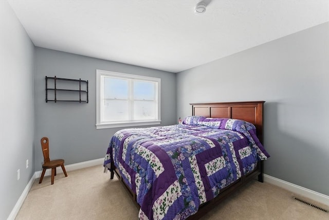 carpeted bedroom featuring baseboards and visible vents