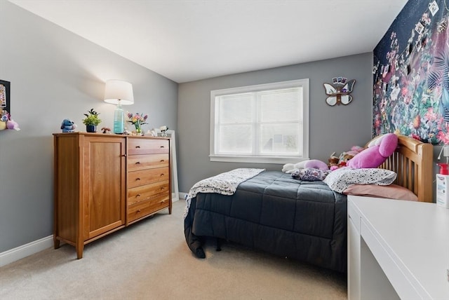 bedroom with baseboards and light colored carpet