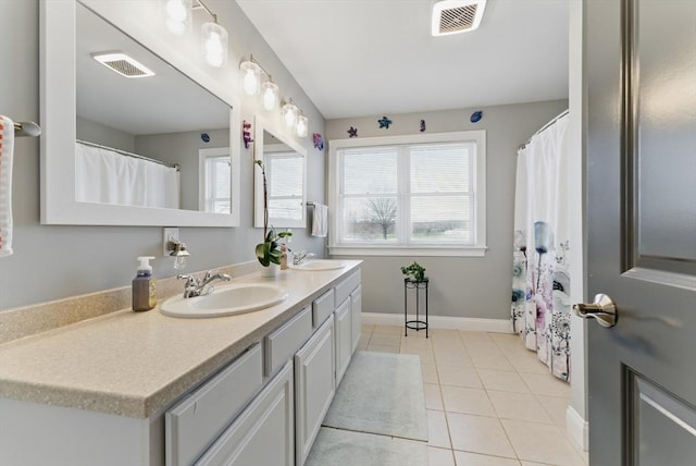 full bath featuring baseboards, tile patterned flooring, a sink, and visible vents