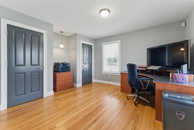 office area with light wood-style flooring and baseboards