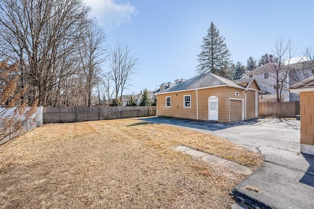 exterior space with a yard, driveway, and a fenced backyard