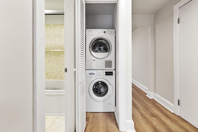 12 Fayette Unit B, Boston, MA 02116 - laundry room featuring stacked washer / dryer and wood finished floors