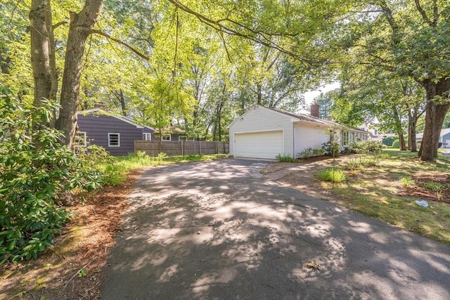 70 Ferncroft St, Longmeadow, MA 01106 - view of property exterior featuring driveway and a chimney