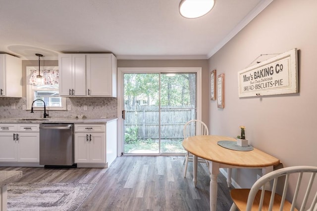 70 Ferncroft St, Longmeadow, MA 01106 - kitchen with stainless steel dishwasher, light wood finished floors, white cabinets, decorative backsplash, and ornamental molding