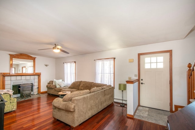 living room featuring a baseboard radiator, dark hardwood / wood-style floors, a healthy amount of sunlight, and ceiling fan