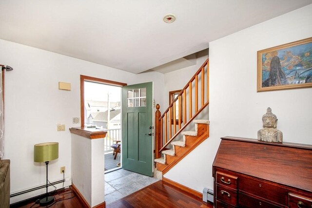 foyer entrance with stairs, baseboards, and a baseboard radiator