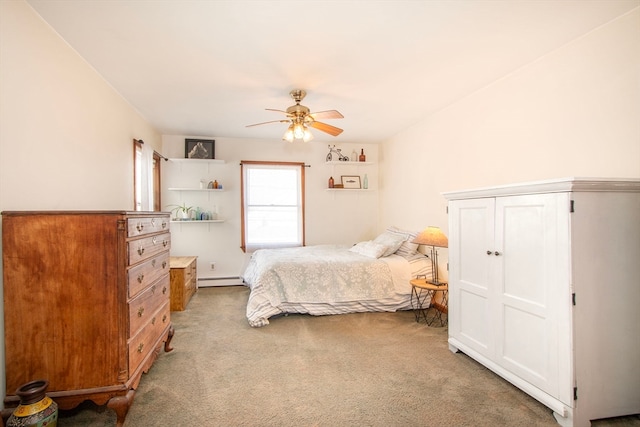 carpeted bedroom featuring a baseboard heating unit and ceiling fan