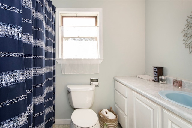 bathroom featuring vanity, a shower with shower curtain, and toilet