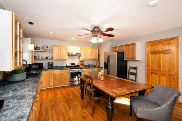 kitchen with light brown cabinets, light hardwood / wood-style flooring, stainless steel appliances, decorative light fixtures, and ceiling fan