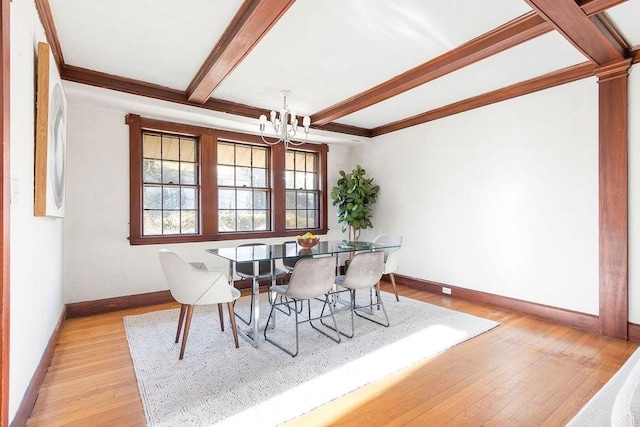 dining room with light hardwood / wood-style floors, beamed ceiling, and a notable chandelier