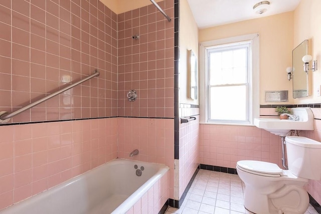 bathroom with plenty of natural light, tile walls, tile patterned floors, and tiled shower / bath