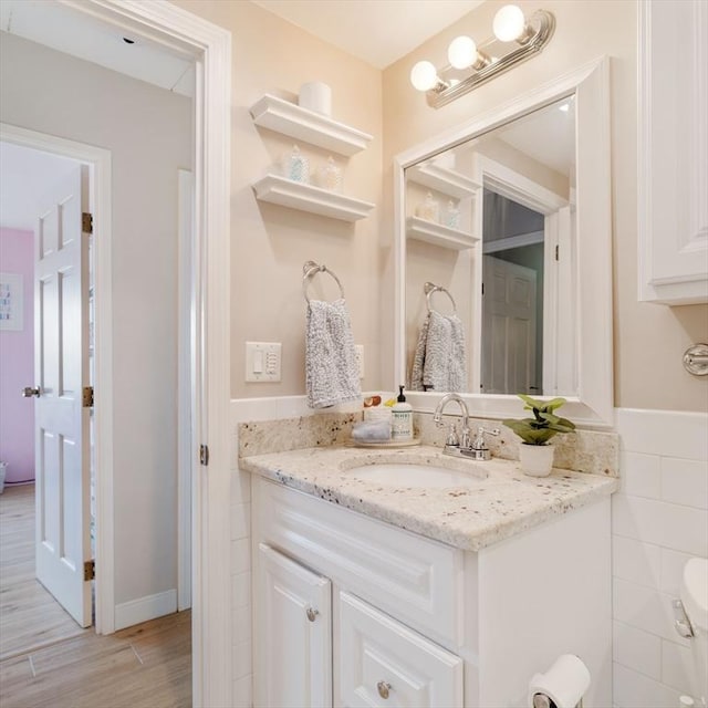 157 Franklin St Unit D3, Stoneham, MA 02180 - bathroom with vanity, wood finished floors, and tile walls