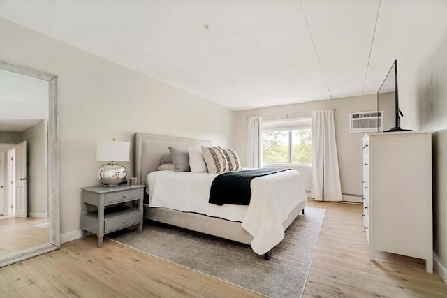 157 Franklin St Unit D3, Stoneham, MA 02180 - bedroom with light wood-style flooring, a wall mounted AC, and a baseboard heating unit