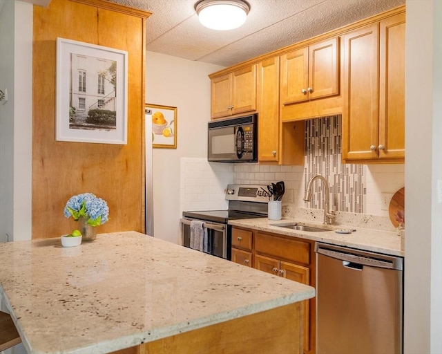 157 Franklin St Unit D3, Stoneham, MA 02180 - kitchen with appliances with stainless steel finishes, tasteful backsplash, and light stone countertops